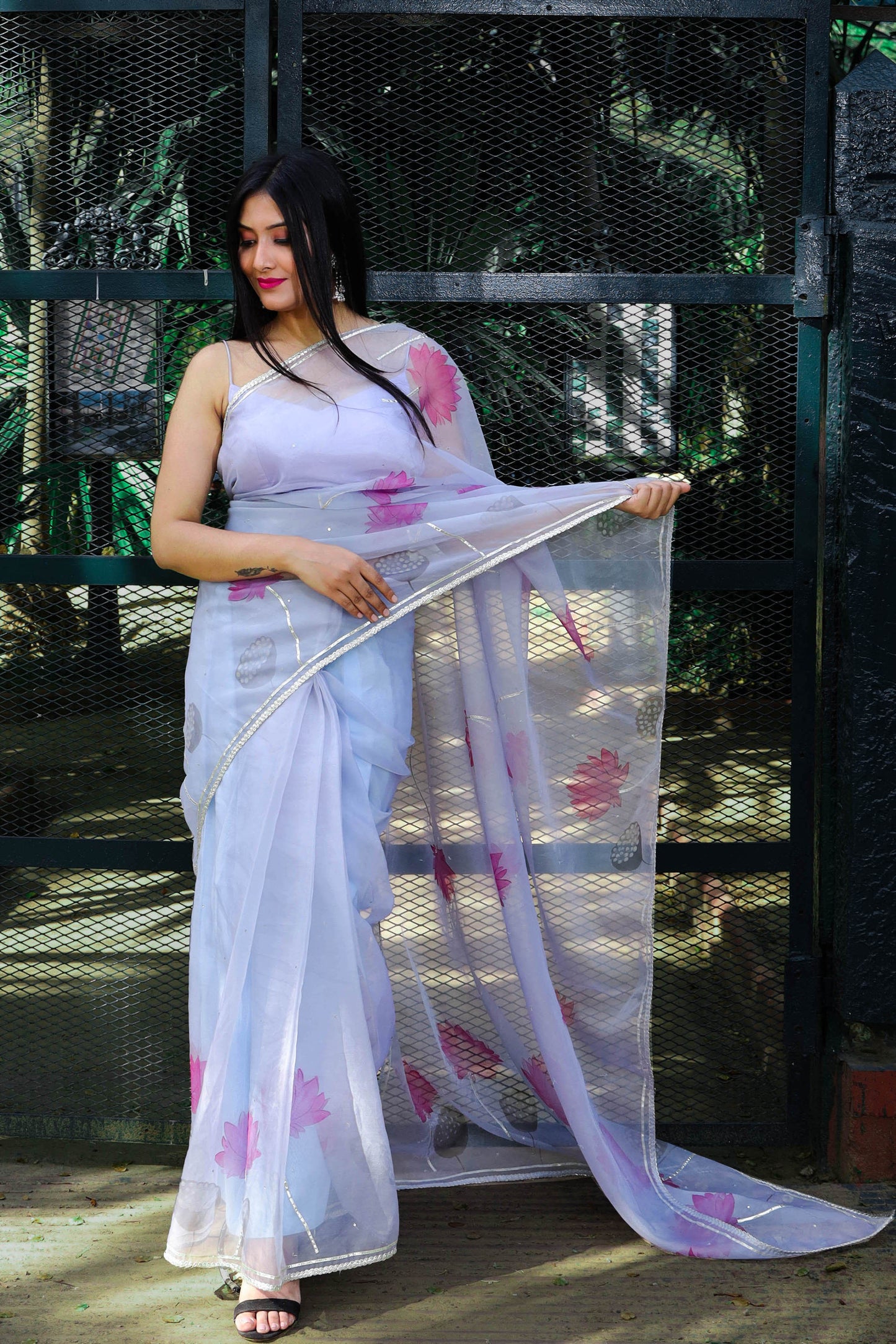 Grey Organza Saree Hand-Painted with Magenta Lotus Flowers and Gota Patti Embroidery - Perfect for Party Wear. Explore the Beauty of Hand-Painted Floral Organza Sarees and Unique Saree Designs. Ideal for an Elegant Organza Saree Look with Intricate Hand Painting