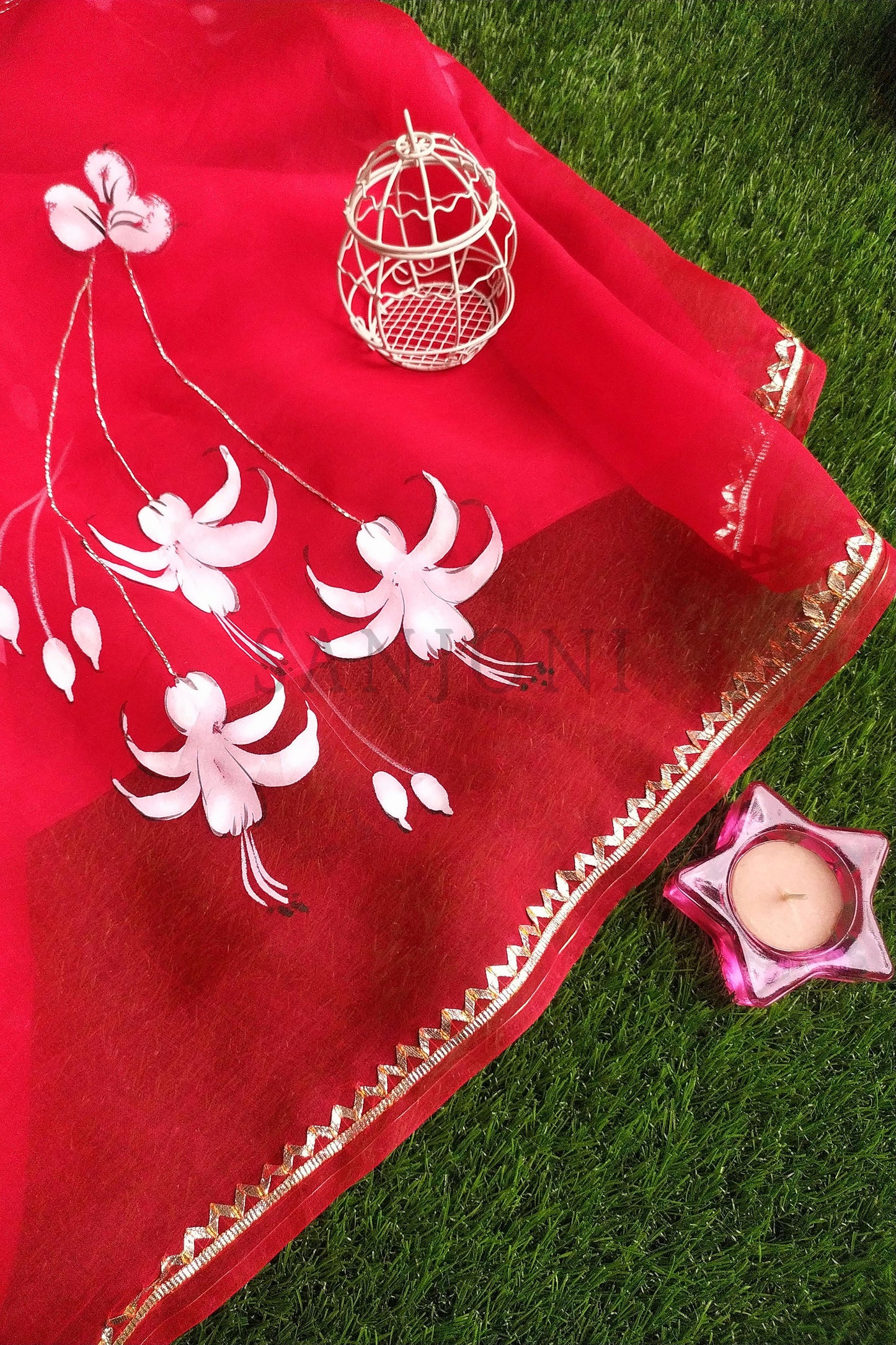 Hand-Painted Red Pure Silk Organza Saree with White Fuchsia Flowers and Metal Gota Embroidery - Perfect for Indian Weddings and Parties. Shop this Stunning Organza Saree Online for a Hot Saree Style. This Pure Silk Saree Features Exquisite Cloth Painting and Textile Paint for Fabric, Making it a Unique Hand-Painted Saree. Get the Saree Look You Desire with this Simple Saree Design. Explore Our Saree Shop for More Sadi Ka Design and Saree Options.