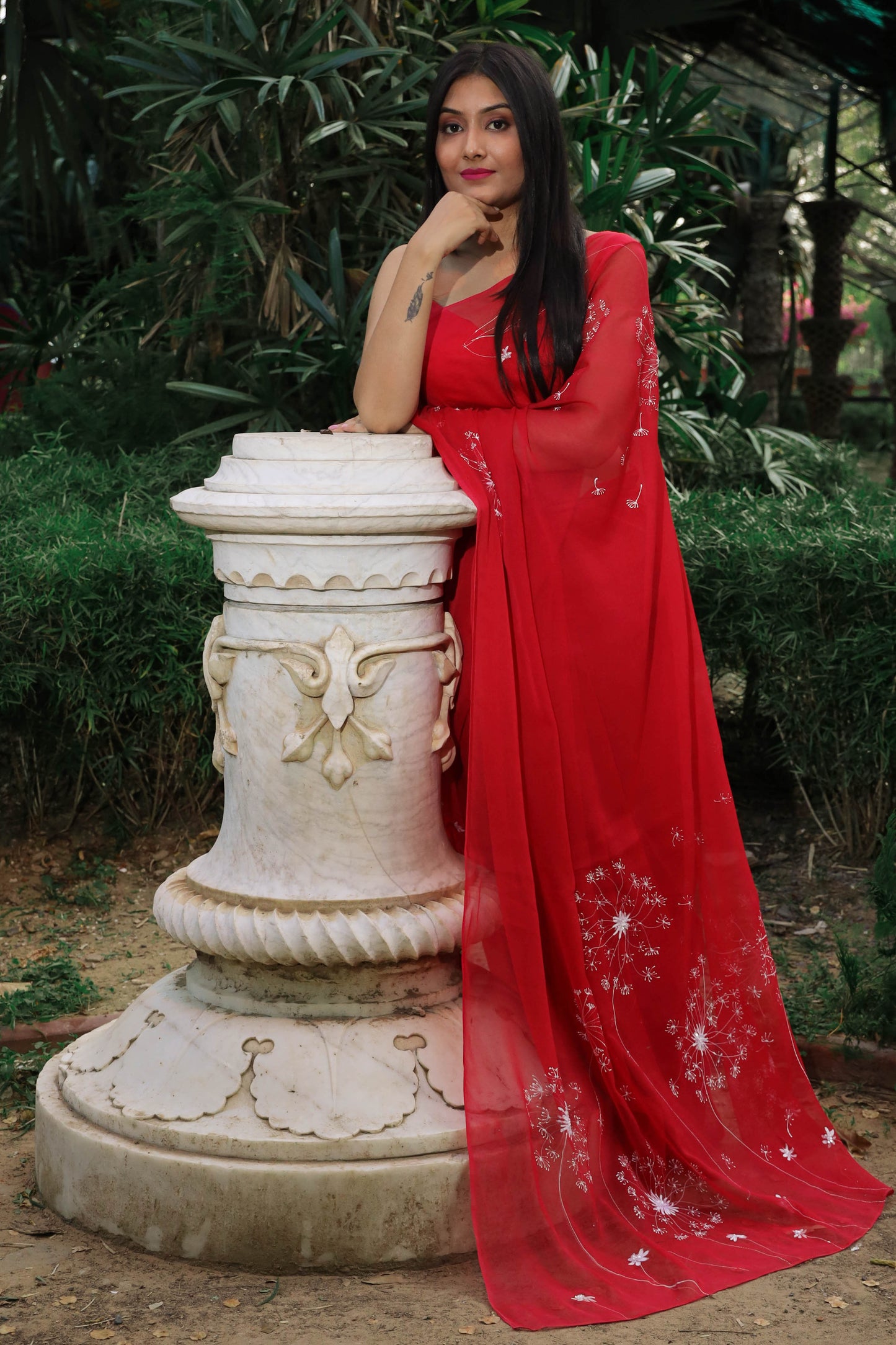 Hand painted red chiffon dandelion saree enhanced with sequin and pearl embroidery.