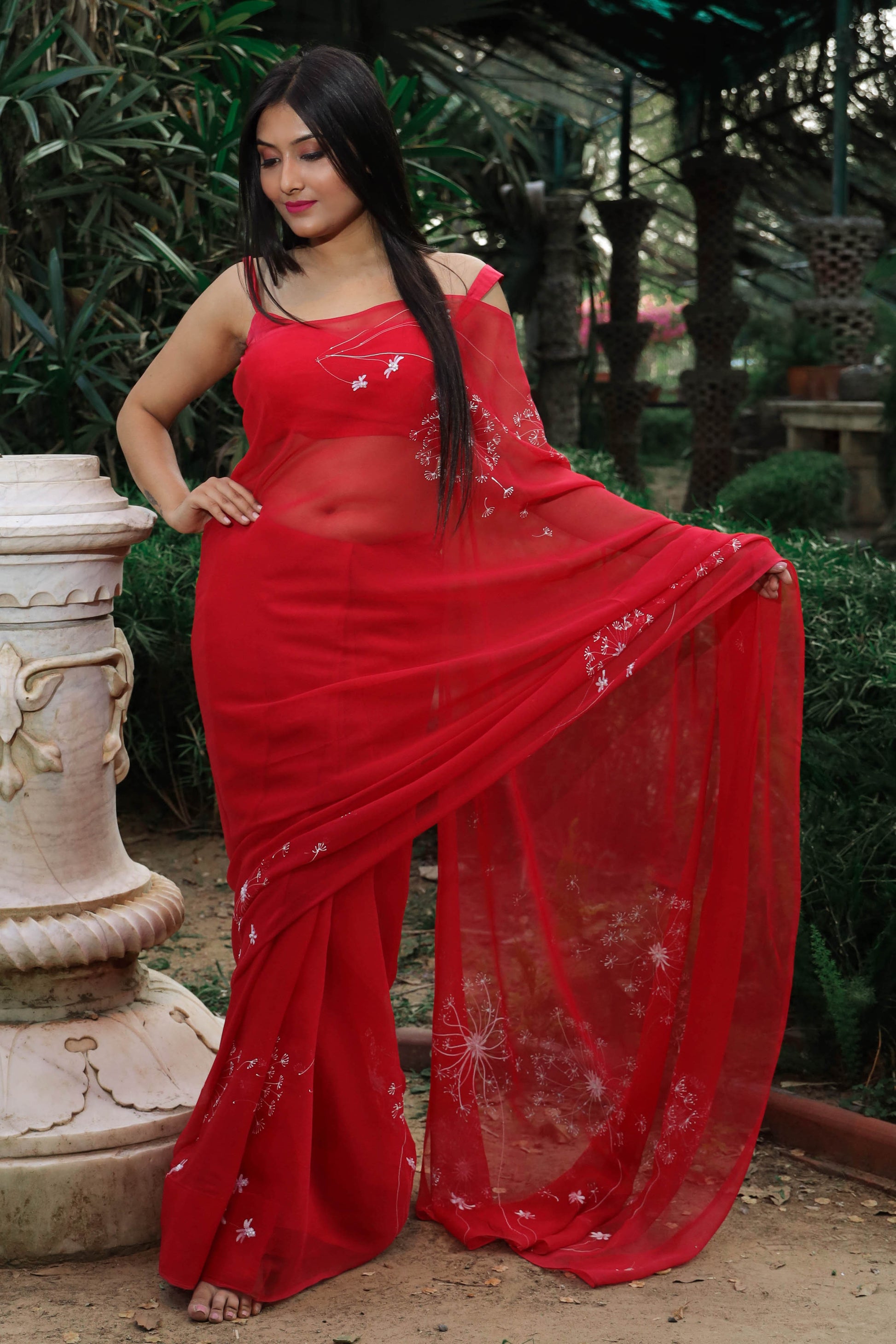 Hand painted red chiffon dandelion saree enhanced with sequin and pearl embroidery.