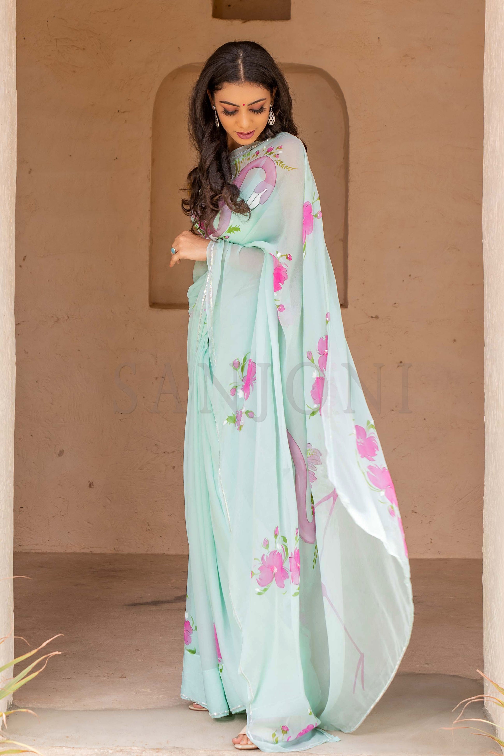 "Explore our exquisite collection of hand-painted sarees, including stunning floral chiffon sarees, funky and beautiful handloom sarees. Our hand-painted sarees are perfect for casual weddings and rustic-themed weddings, featuring intricate handwork and embroidery. Don't miss our trending Bollywood sarees, and for a touch of elegance, check out our chiffon hand-painted sarees in aqua colors. Discover the perfect saree for every occasion."