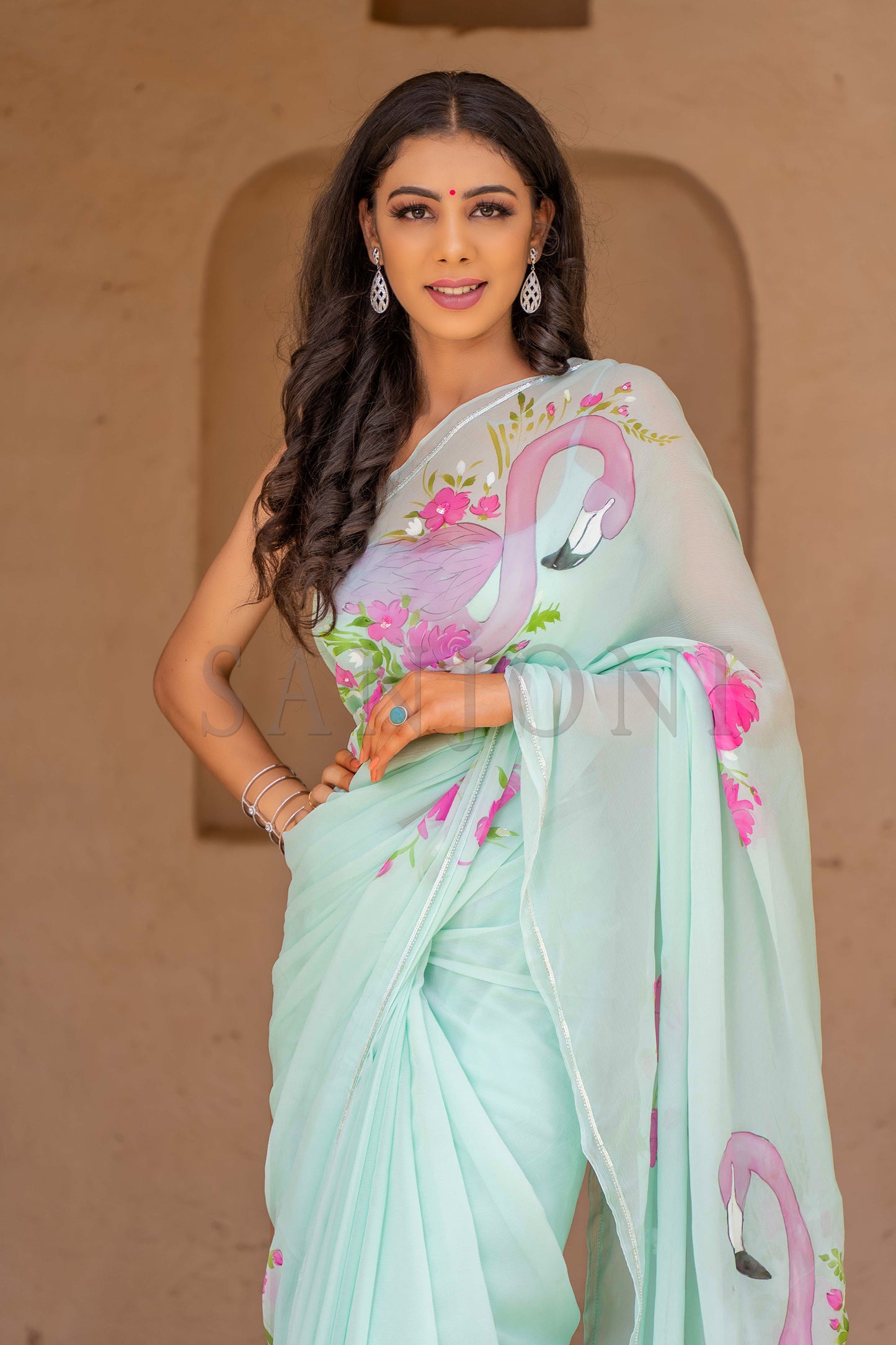 "Explore our exquisite collection of hand-painted sarees, including stunning floral chiffon sarees, funky and beautiful handloom sarees. Our hand-painted sarees are perfect for casual weddings and rustic-themed weddings, featuring intricate handwork and embroidery. Don't miss our trending Bollywood sarees, and for a touch of elegance, check out our chiffon hand-painted sarees in aqua colors. Discover the perfect saree for every occasion."