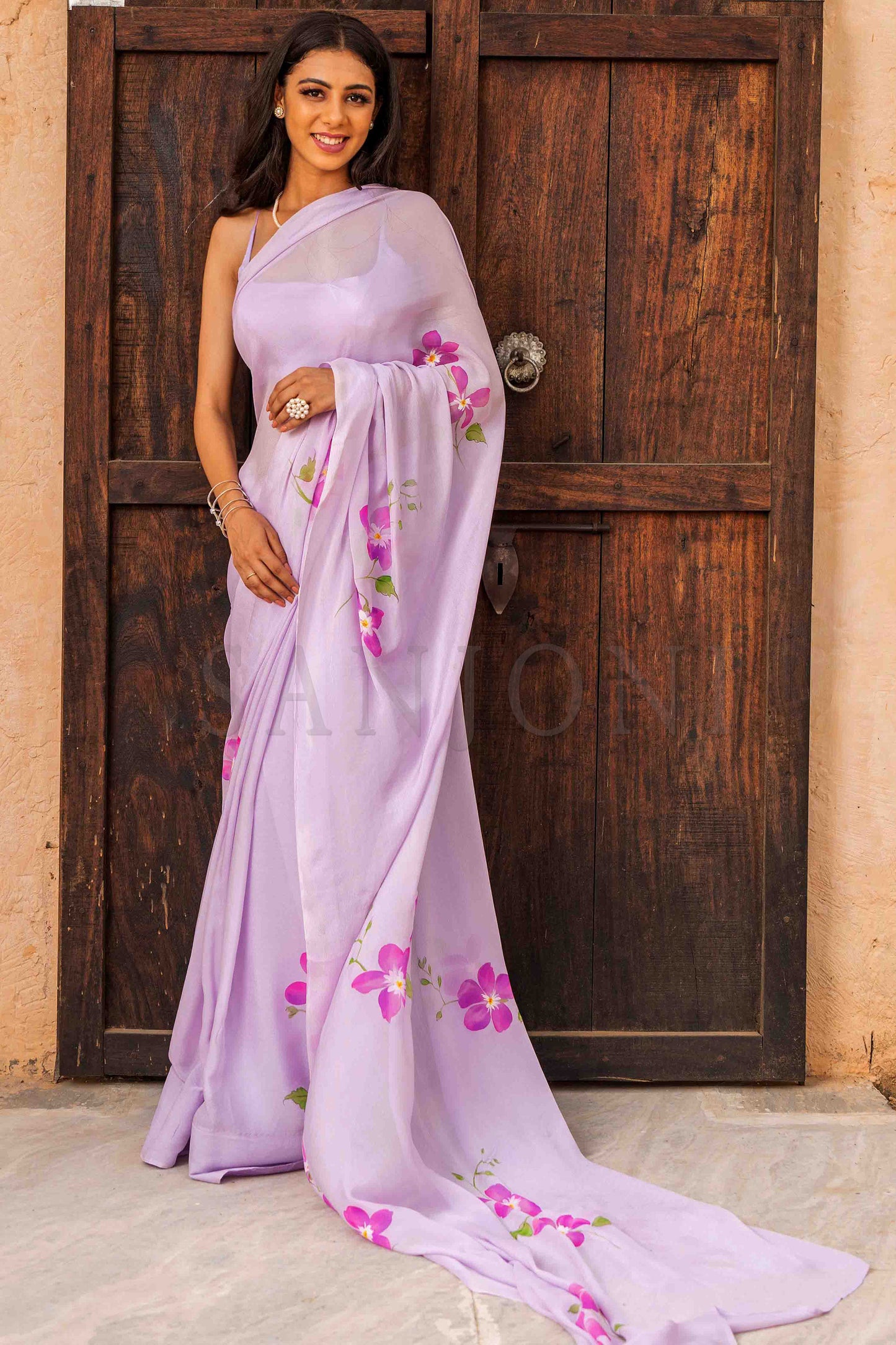 hand painted orchid chinon chiffon saree in lilac shade enhanced with bead and sequin work.