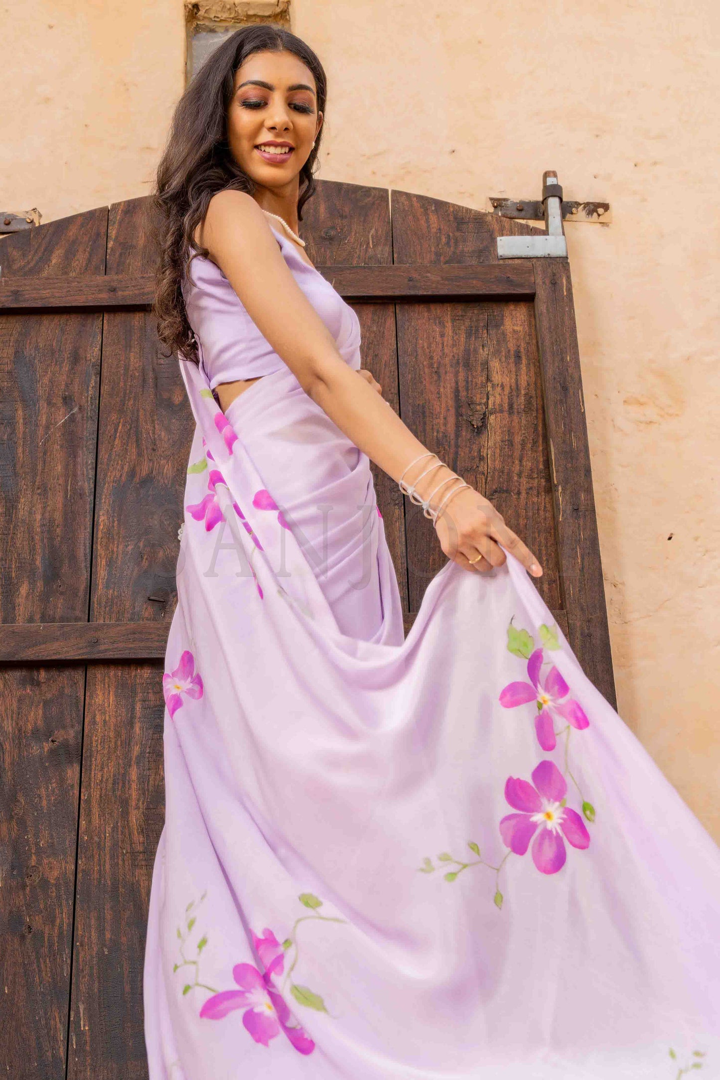 best price hand painted chinon chiffon saree with orchid flowers painted allover enhanced with beads and sequin work.