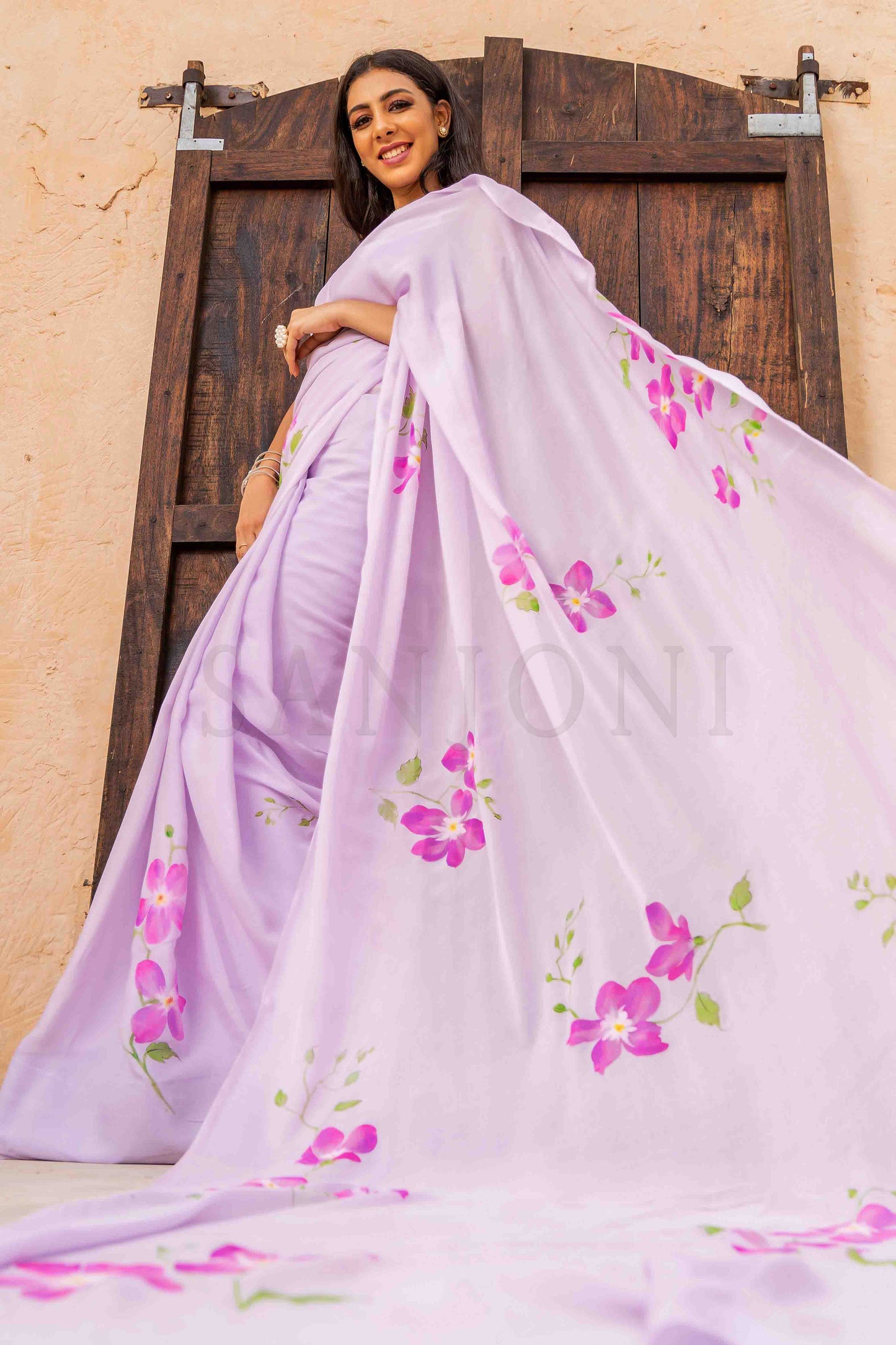 best price hand painted chinon chiffon saree with orchid flowers painted allover enhanced with beads and sequin work. 