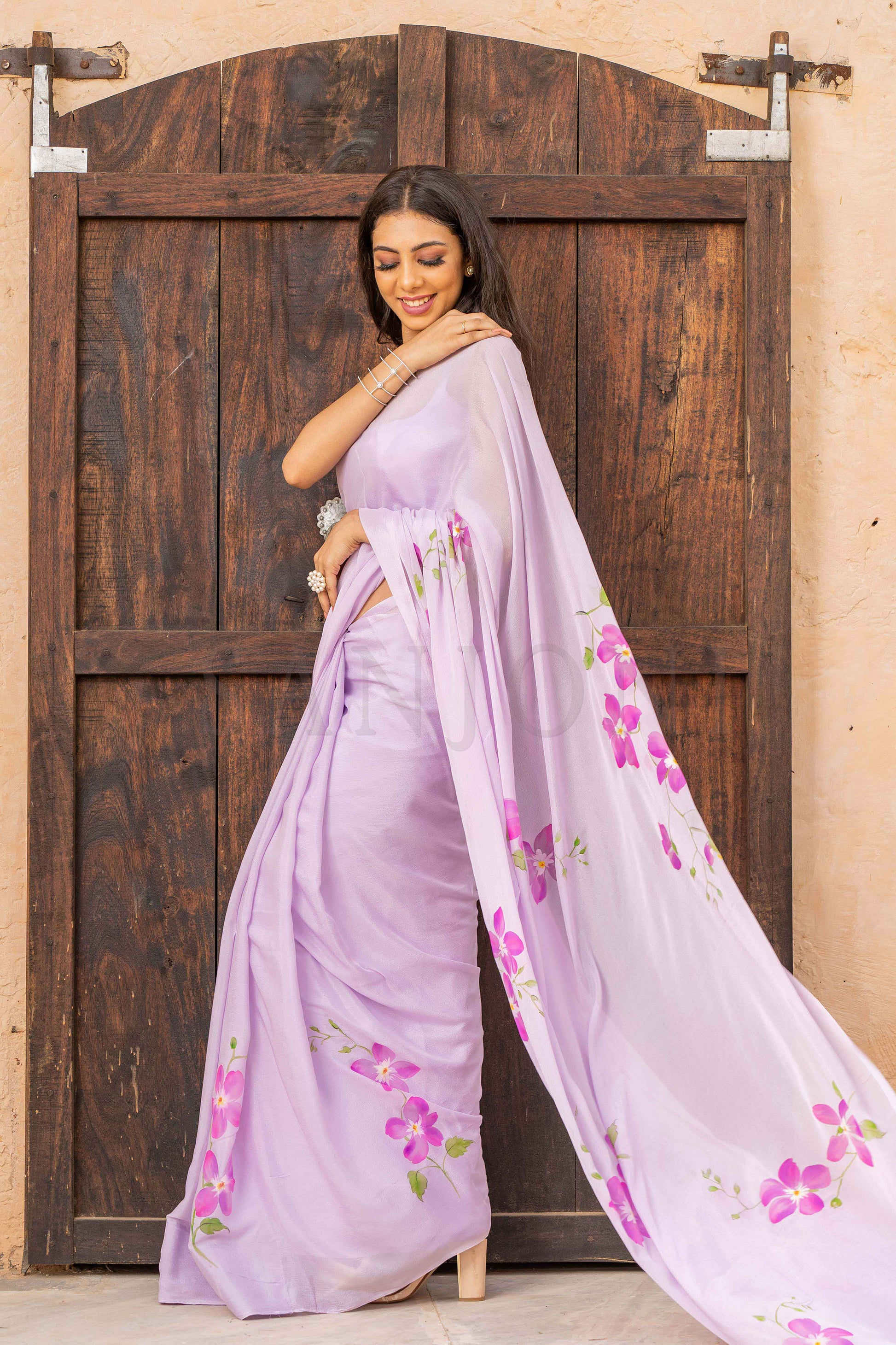 best price hand painted chinon chiffon saree with orchid flowers painted allover enhanced with beads and sequin work. 