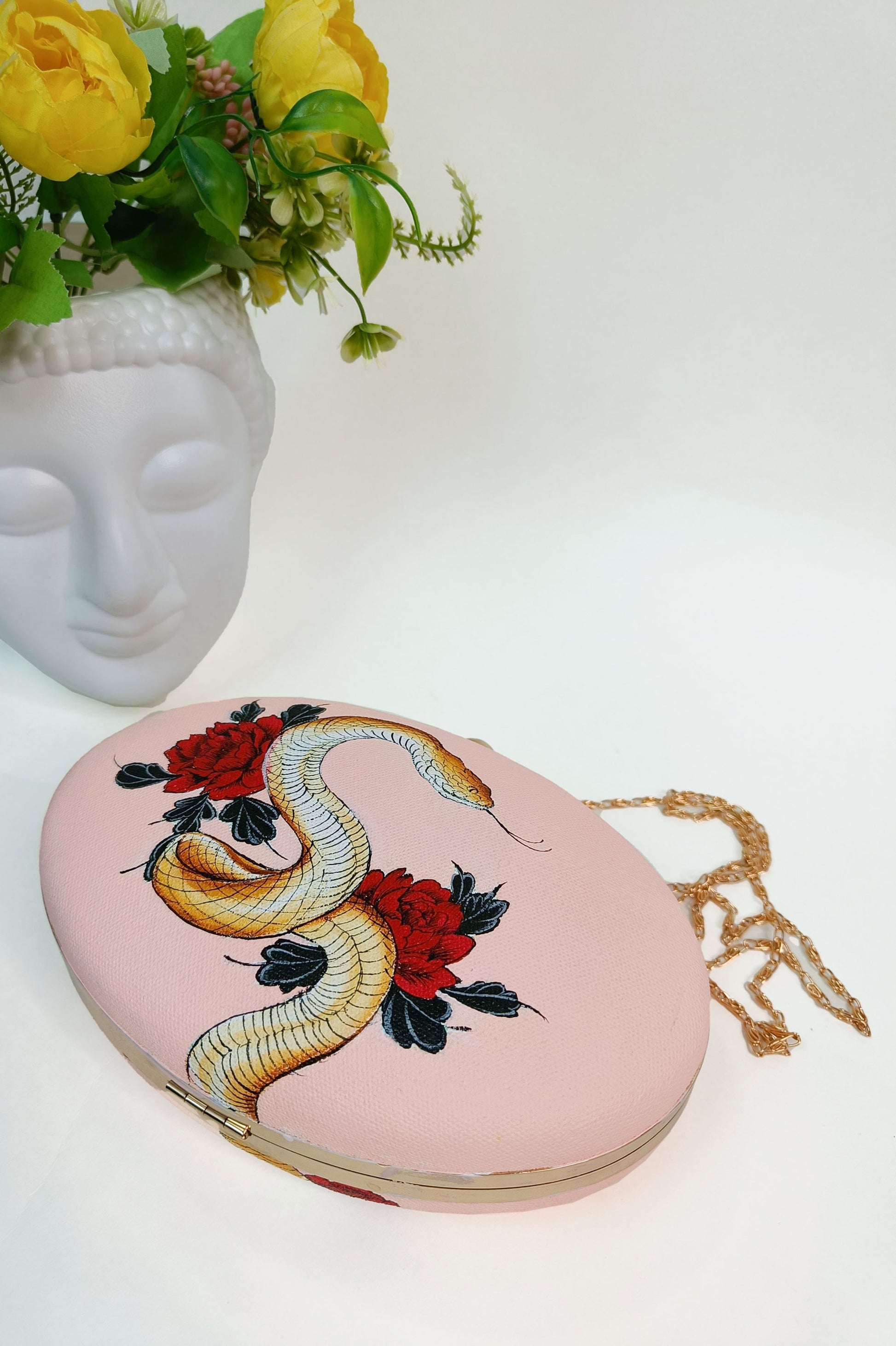 Hand-Painted Clutch with Python sitting on  Red Rose Flowers Design - Customized Canvas Bag with Sling. Unique Hand-Painted Purse for Evening Events. Explore our Hand-Painted Handbags and Customized Ladies Purse with Name Options. Perfect Bag Design Online. Ideal for a Personalized and Stylish Look. Get Your Painted Designer Bag Today