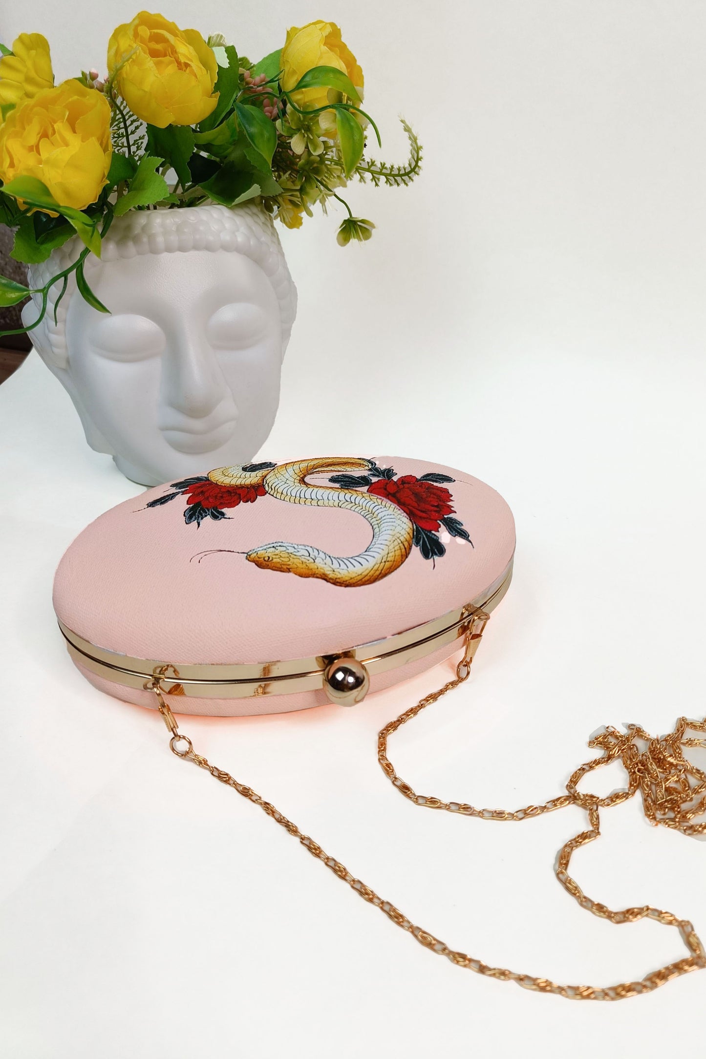 Hand-Painted Clutch with Python sitting on Red Rose Flowers Design - Customized Canvas Bag with Sling. Unique Hand-Painted Purse for Evening Events. Explore our Hand-Painted Handbags and Customized Ladies Purse with Name Options. Perfect Bag Design Online. Ideal for a Personalized and Stylish Look. Get Your Painted Designer Bag Today