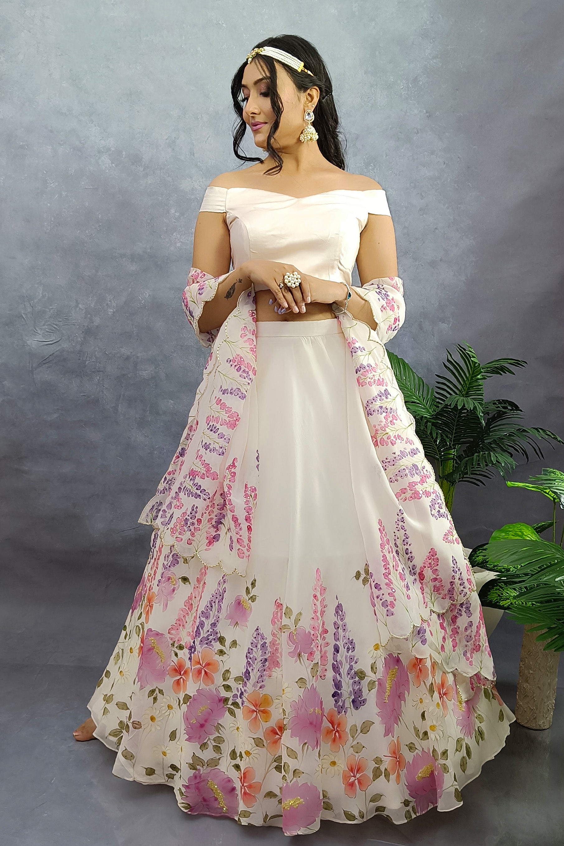 Hand painted winter garden organza lehenga in milky white color, enhanced with sequin embroidery