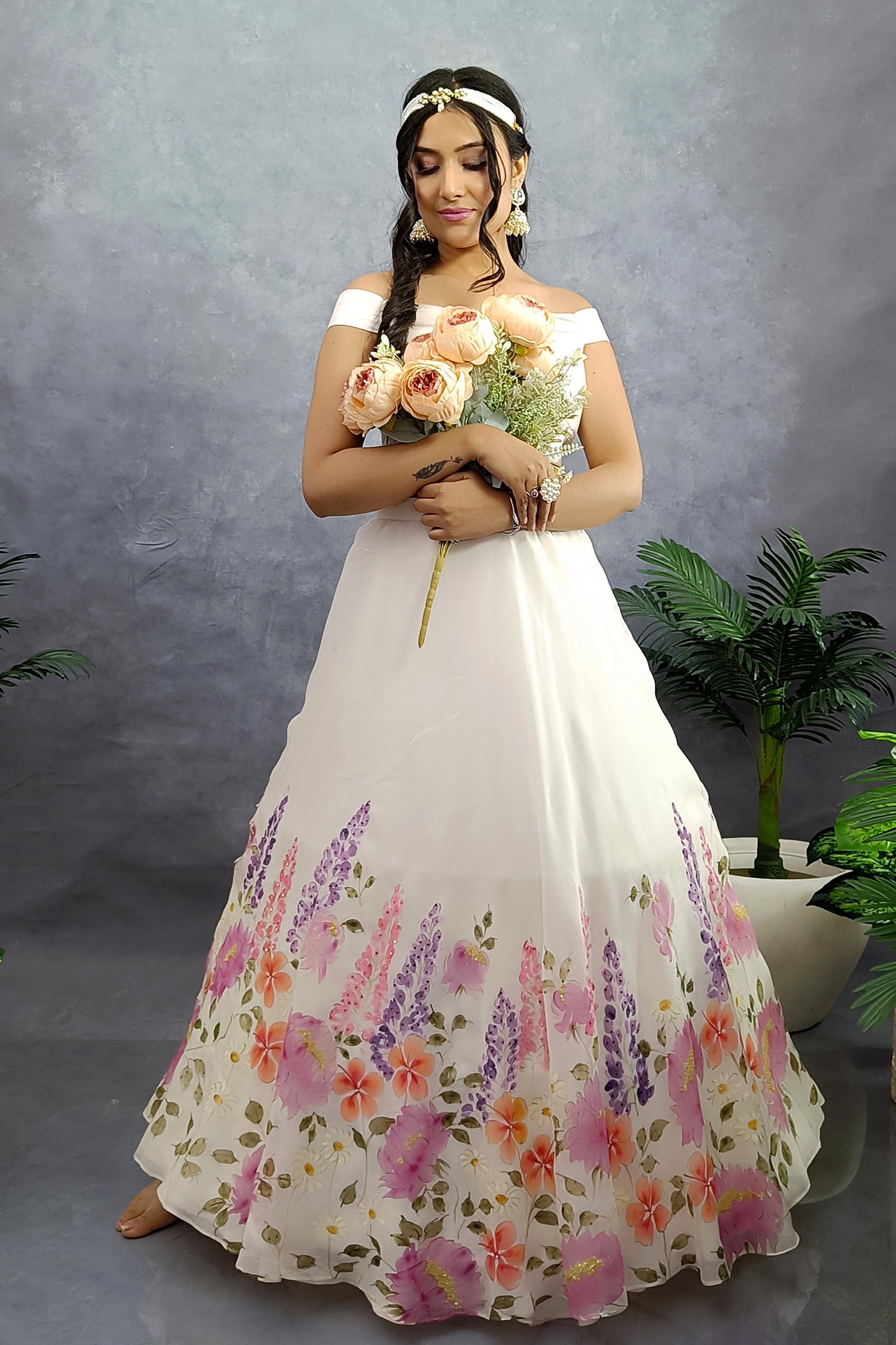 Hand painted hand embroidered winter garden organza lehenga in milky white color.