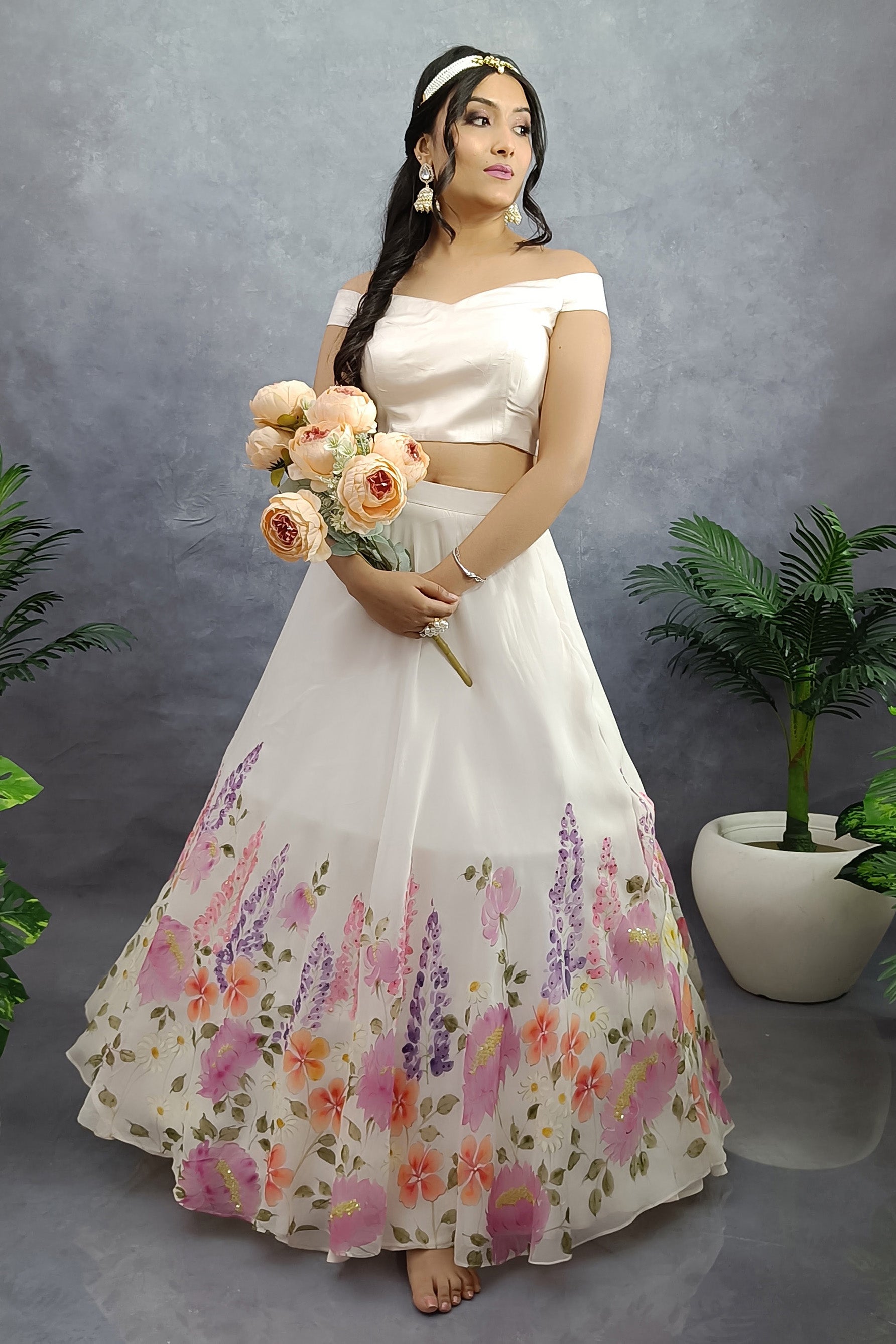 Hand painted hand embroidered winter garden organza lehenga in milky white color.
