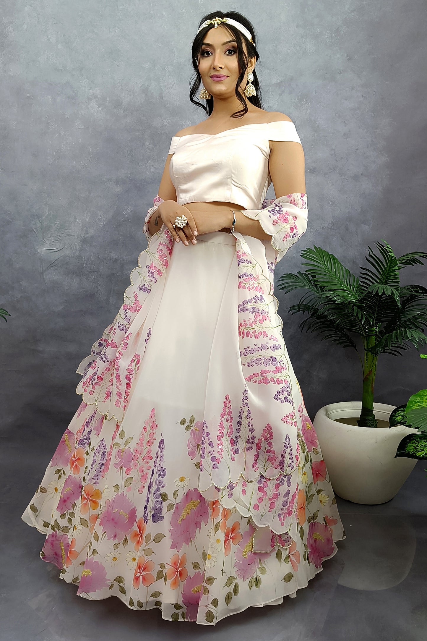 Hand painted hand embroidered winter garden organza lehenga in milky white color.