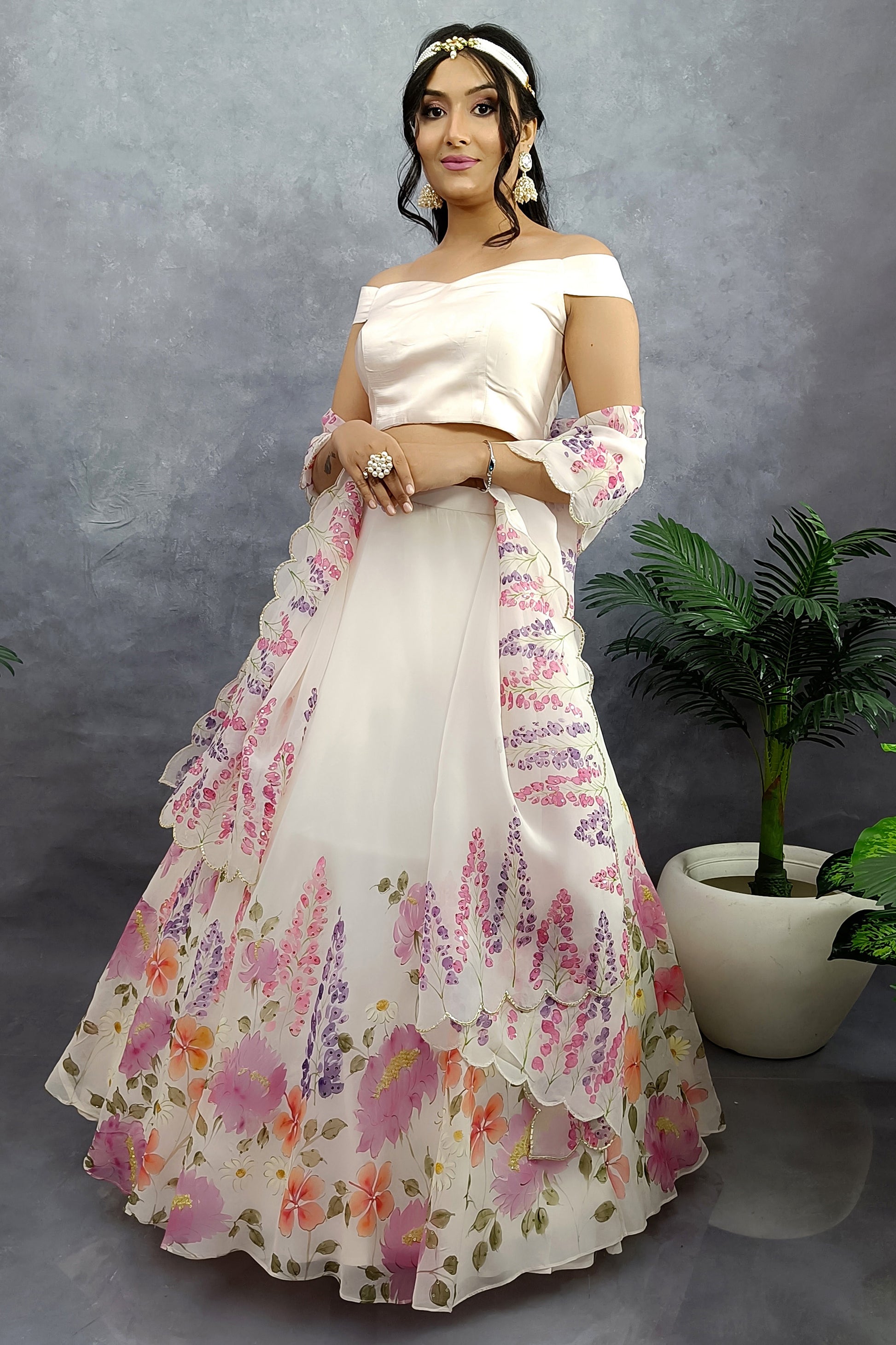 Hand painted hand embroidered winter garden organza lehenga in milky white color.