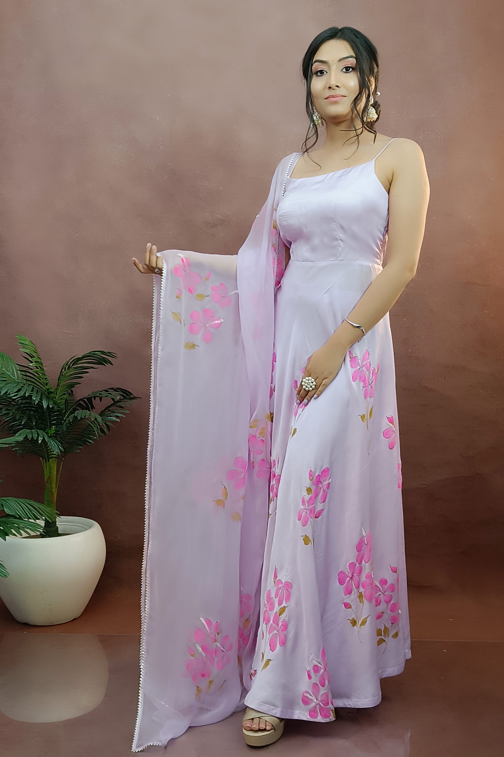 Hand painted lavender color modal satin anarkali suit with chiffon dupatta enhanced with pearl dupatta.