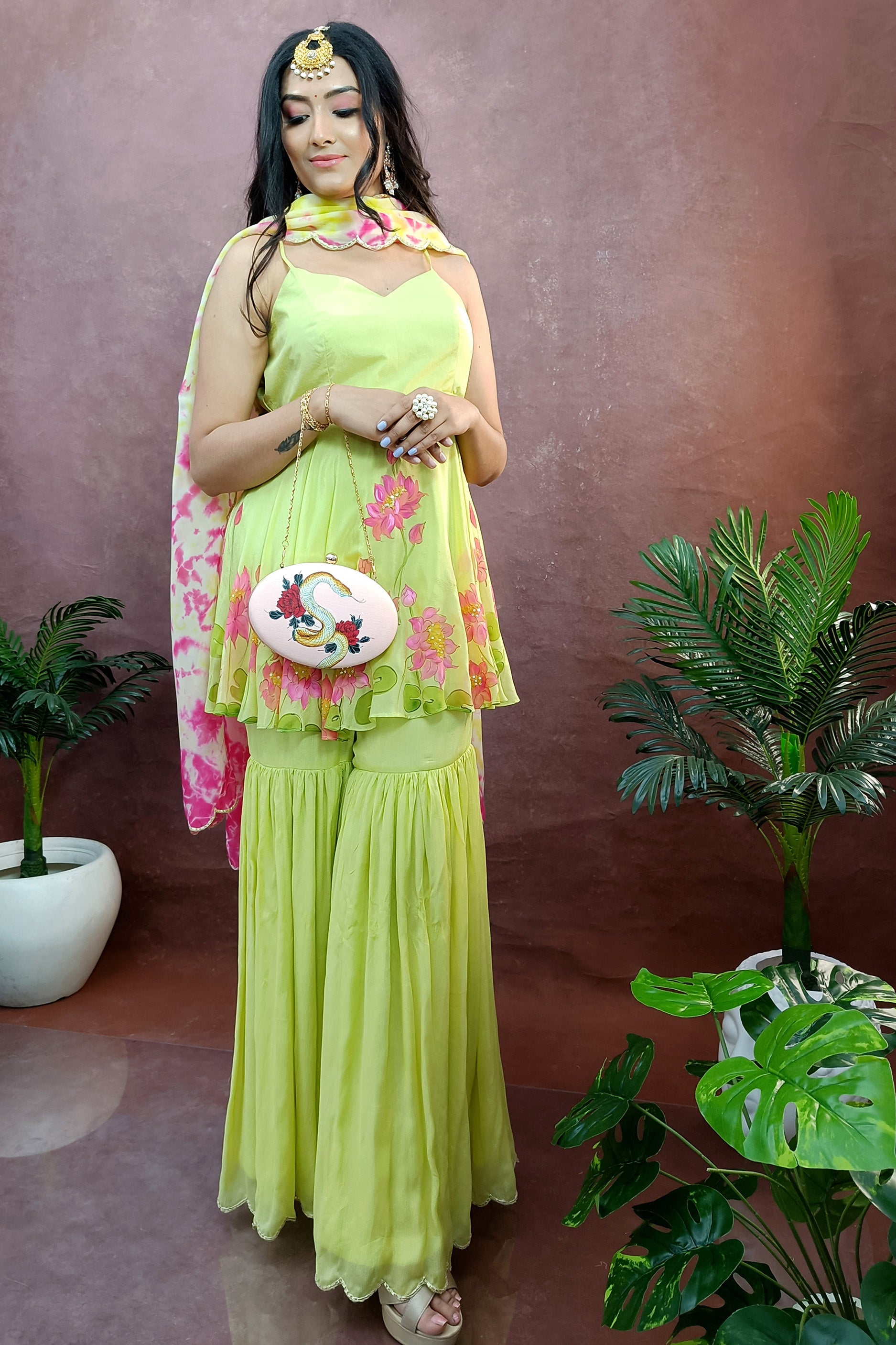 Hand painted lime green lotus sharara design, paired with tie & die organza dupatta, enhanced with sequin and gota embroidery.