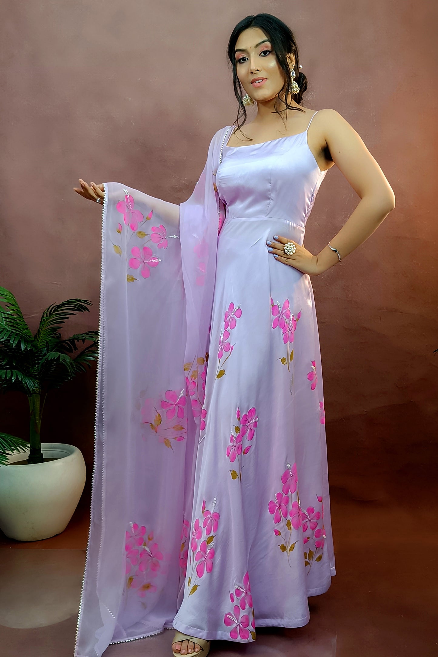 Hand painted lavender anarkali suit in modal satin with fuchsia hibiscus anarkali paired with chiffon dupatta enhanced with pearl dupatta.