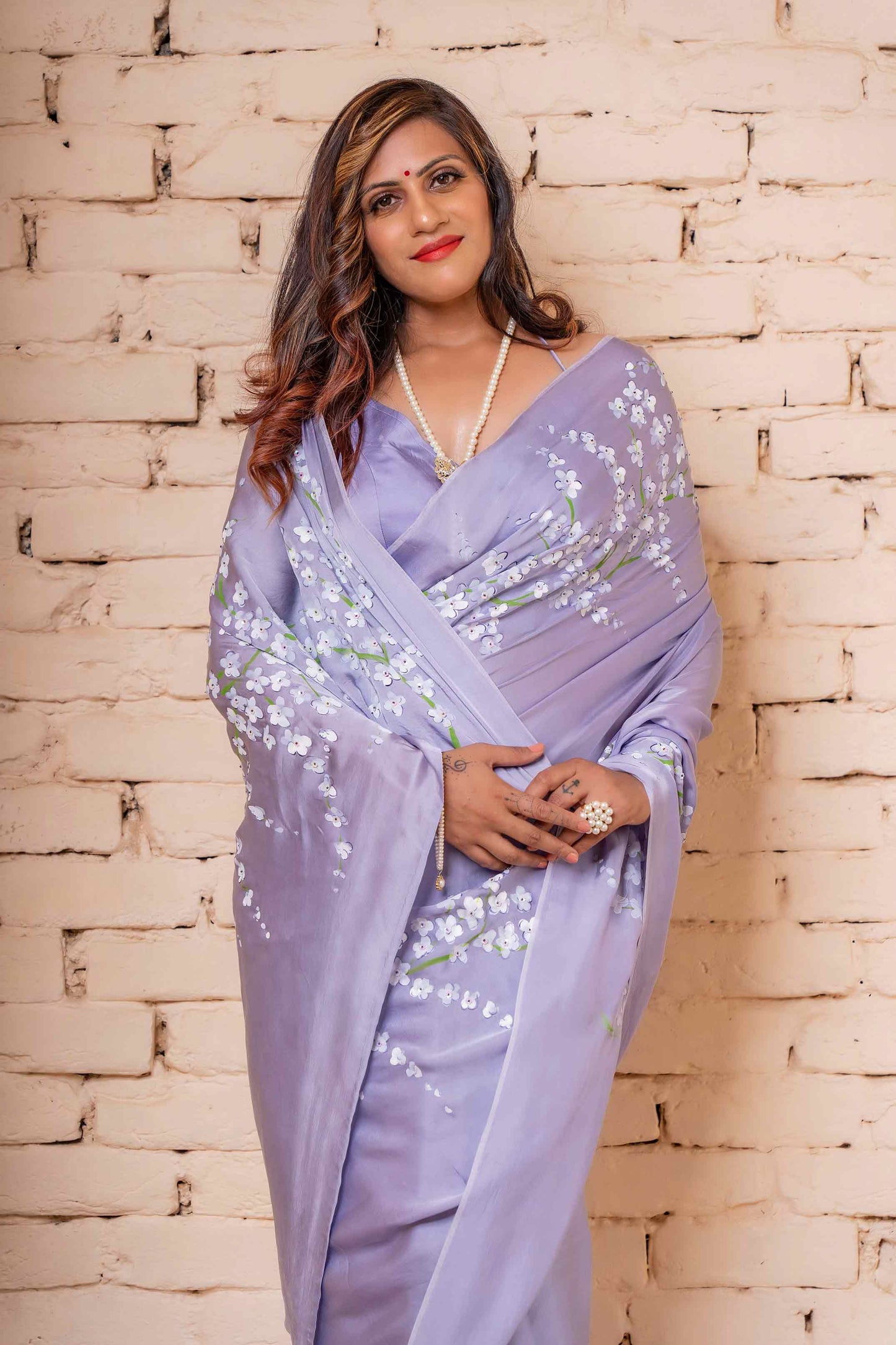 Lavender Satin Silk Saree Hand-Painted with White Apple Blossoms and Sequin Hand Embroidery - Perfect for Party Wear. Explore the Elegance of Hand-Painted Floral Sarees and Unique Saree Designs. Achieve a Hot Saree Style with This Pure Silk Saree. Ideal for an Engagement Look in Saree or a Farewell Saree Look. Discover Easy Hand-Painted Saree Design with Intricate Hand Painting. Elevate Your Saree Look for Weddings and Parties with This Beautiful and Stylish Indian Saree.