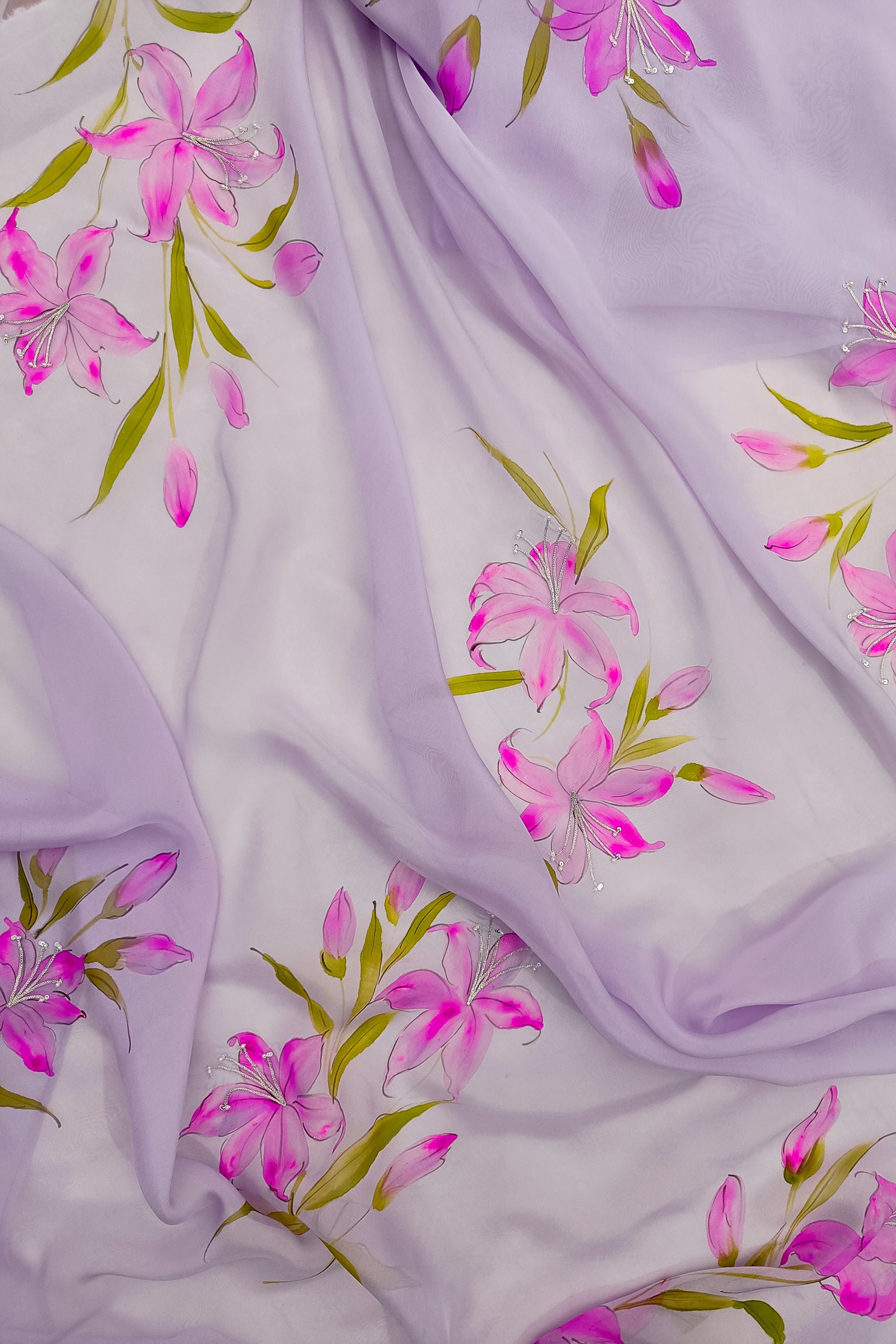 Floral fabric with pink flowers and green leaves on a light purple background