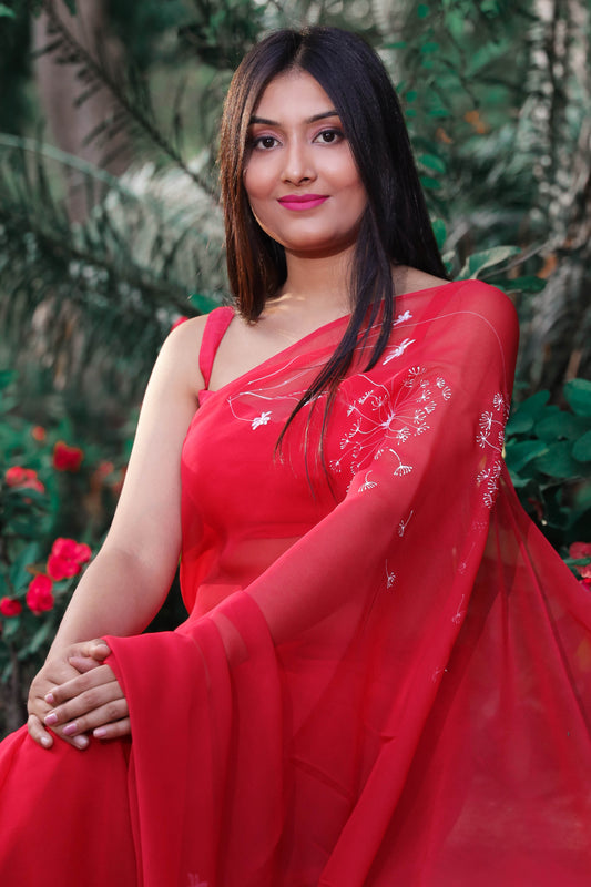 Hand painted red chiffon dandelion saree enhanced with sequin and pearl embroidery.