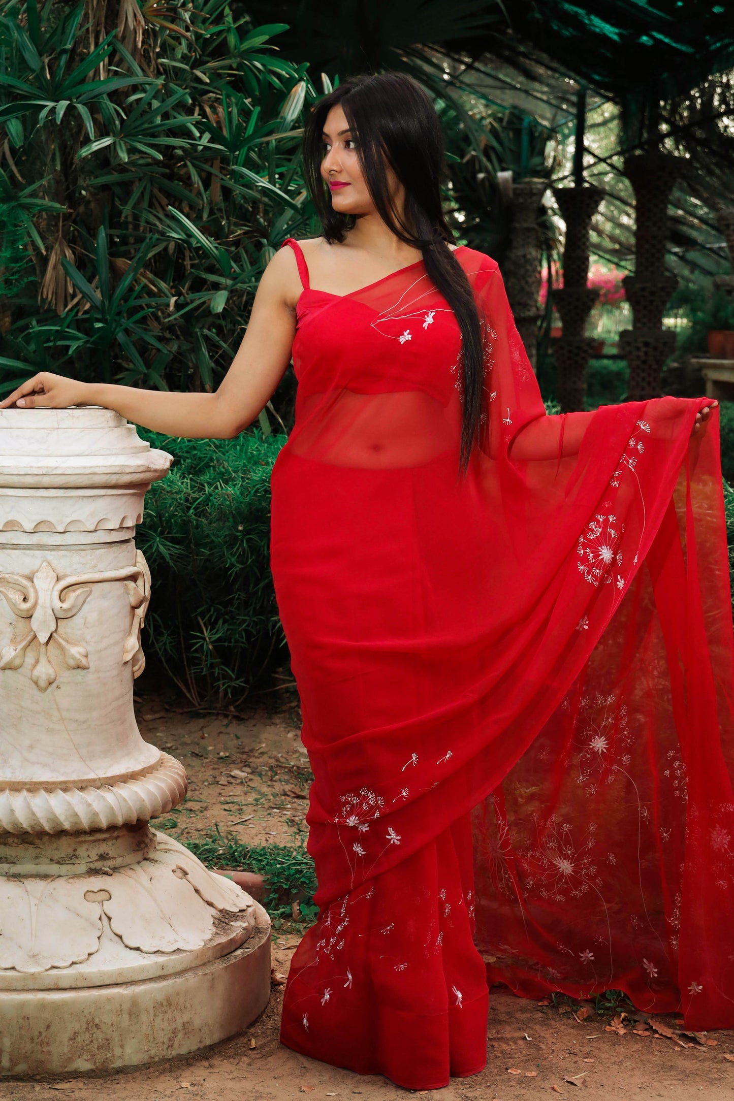 Hand painted red chiffon dandelion saree enhanced with sequin and pearl embroidery.