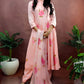Peach color hand painted anarkali suit with bright pink roses enhanced with beads and sequin embroidery.