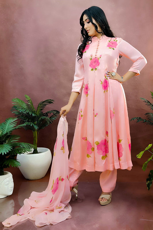 Peach color hand painted anarkali suit with bright pink roses enhanced with beads and sequin embroidery.