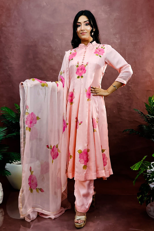 Peach color hand painted anarkali suit with bright pink roses enhanced with beads and sequin embroidery.