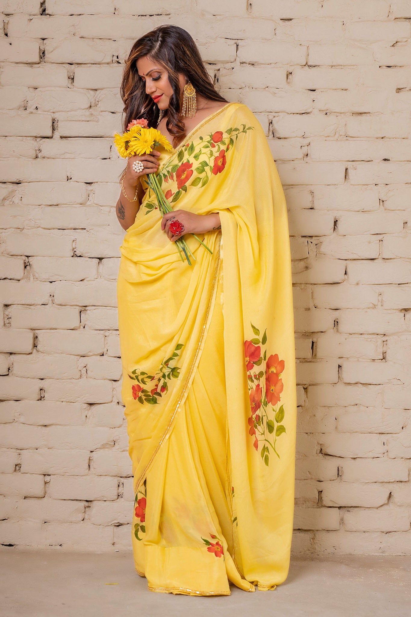 Explore our hand-painted sarees, a fusion of artistry and elegance. Find the perfect hand-paint sari, whether it's a floral chiffon saree for a funky look or a beautiful handloom saree that's trending now. Elevate your style with a Bollywood saree or go rustic with a crêpe silk embroidered saree. Discover the finest in craftsmanship and fashion.
