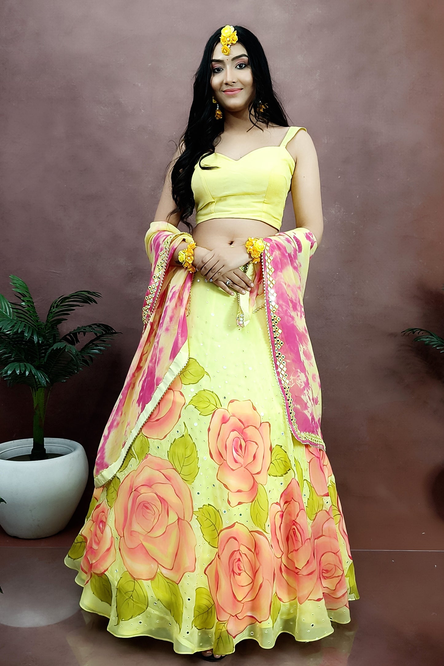 Hand painted yellow color organza rose hand painted lehenga enhanced with mirror work paired with tie and die organza dupatta