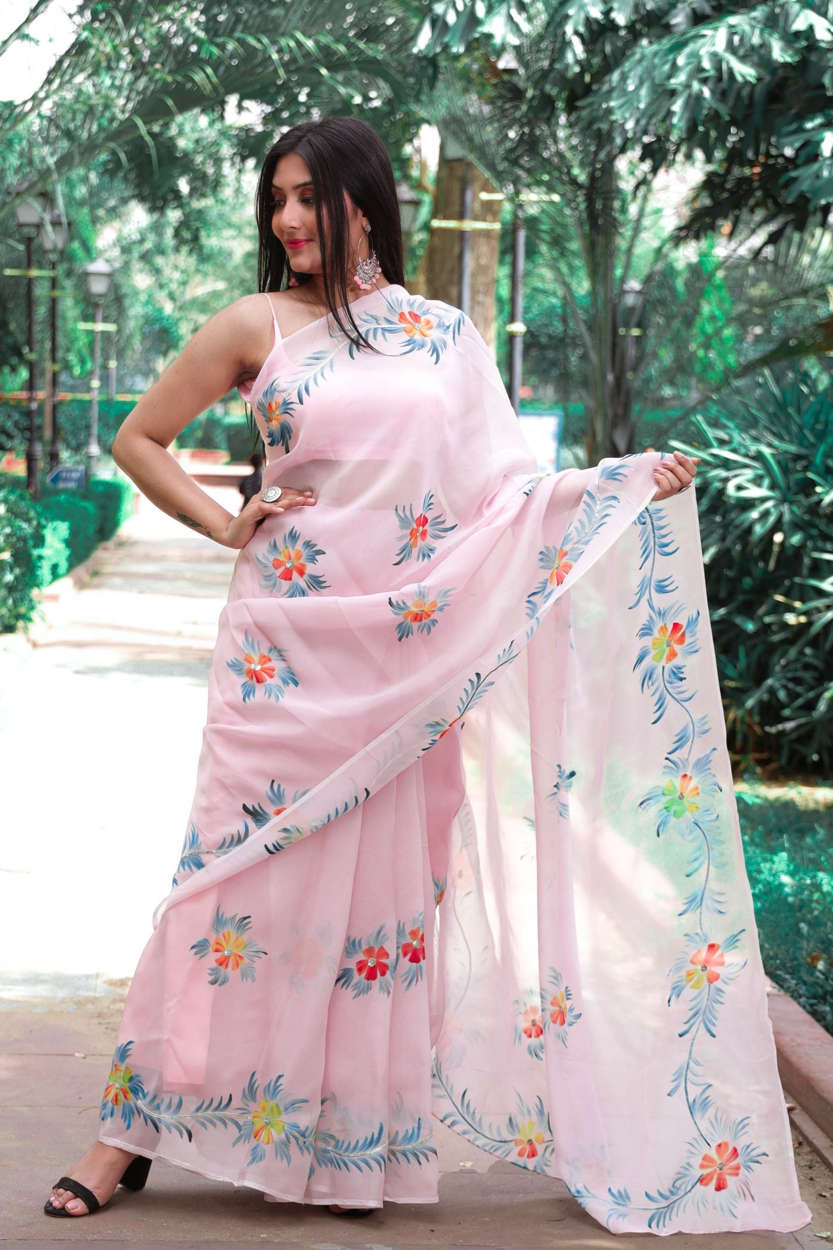 fancy hand painted organza saree in dull pink shade enhanced with sequin and gota detailing.