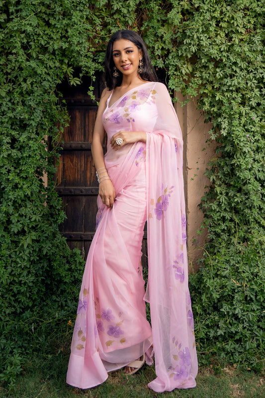 hand painted hibiscus flowers on soft pink chiffon  saree enhanced with sequin and pearl embroidery.