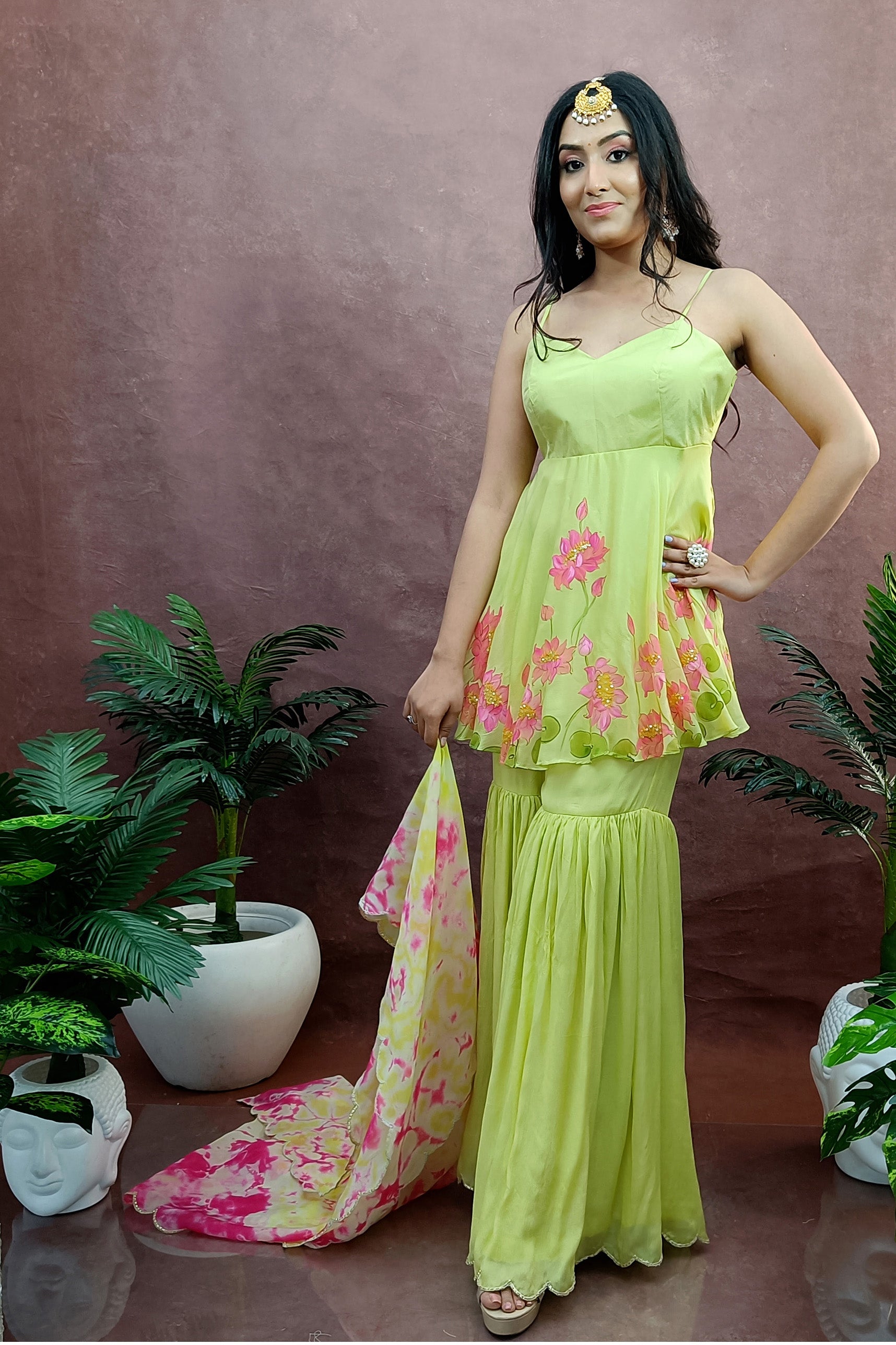 Hand painted lime green lotus sharara design, paired with tie & die organza dupatta, enhanced with sequin and gota embroidery.