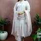 Girl is wearing Hand-painted A-line suit in light move color silk , white color fuchsia flowers enhanced with sequin  and gota embroidery, paitred with an organza dupatta and straight pants.